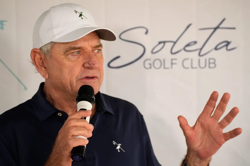 Picture of Nick Price in front of the Soleta Golf Club Logo. 